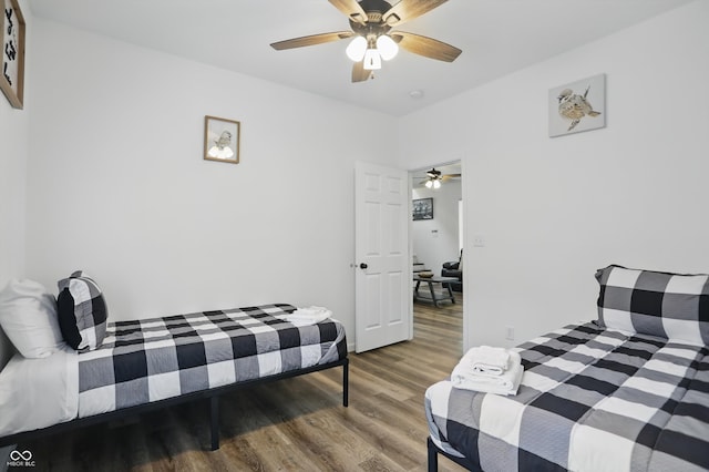bedroom with wood finished floors and a ceiling fan