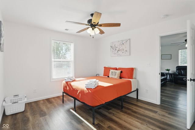 bedroom with wood finished floors, baseboards, and ceiling fan