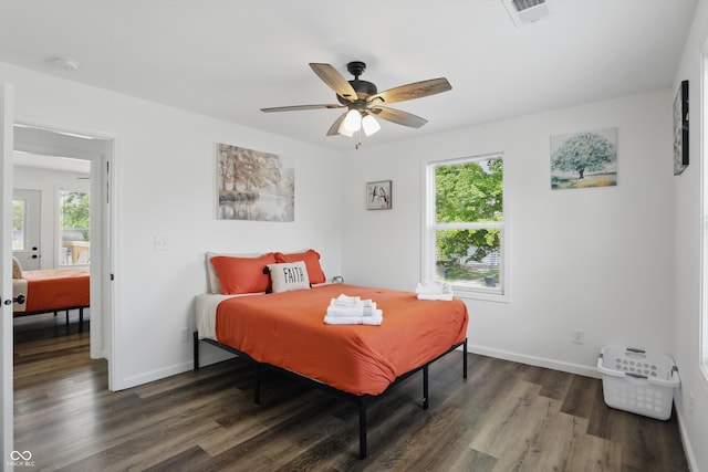 bedroom with wood finished floors, baseboards, and a ceiling fan