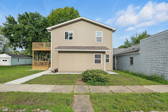 rear view of property with a yard and a deck
