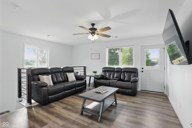 living area with healthy amount of natural light, ceiling fan, and wood finished floors