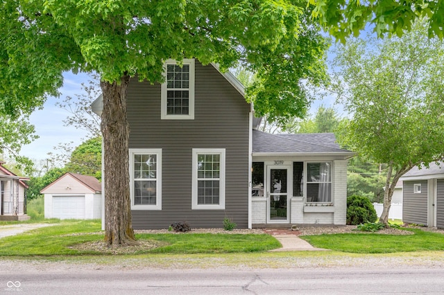3019 W Huntsville Rd, Pendleton, IN 46064 - traditional-style house featuring an outbuilding, a detached garage, driveway, a front yard, and a shingled roof