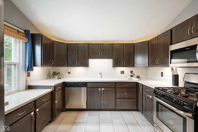 3019 W Huntsville Rd, Pendleton, IN 46064 - kitchen featuring stainless steel appliances, vaulted ceiling, a sink, dark brown cabinets, and light countertops