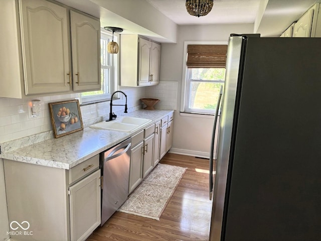 4105 N Cozy Hollow Ln, New Castle, IN 47362 - kitchen with appliances with stainless steel finishes, light countertops, wood finished floors, and backsplash