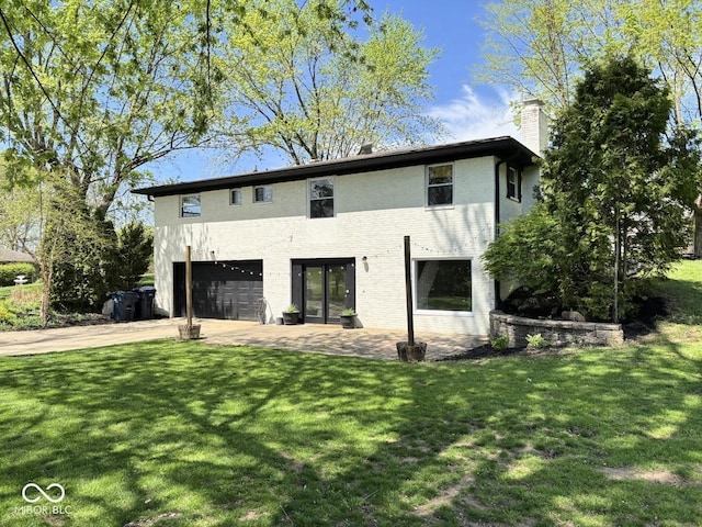 4105 N Cozy Hollow Ln, New Castle, IN 47362 - view of side of property with an attached garage, a chimney, driveway, and a yard