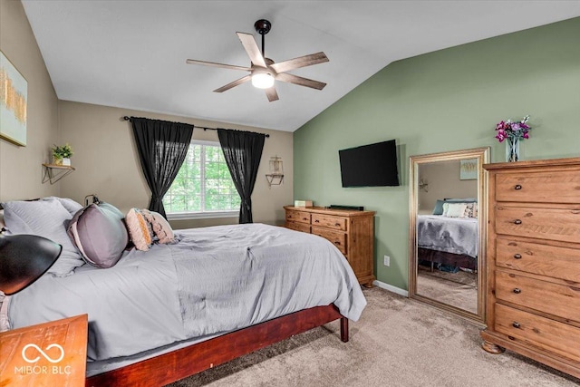bedroom featuring vaulted ceiling, light colored carpet, ceiling fan, and baseboards