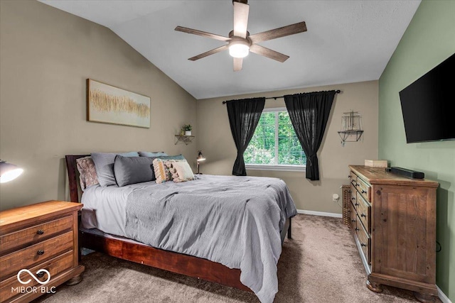 carpeted bedroom featuring vaulted ceiling, baseboards, and a ceiling fan