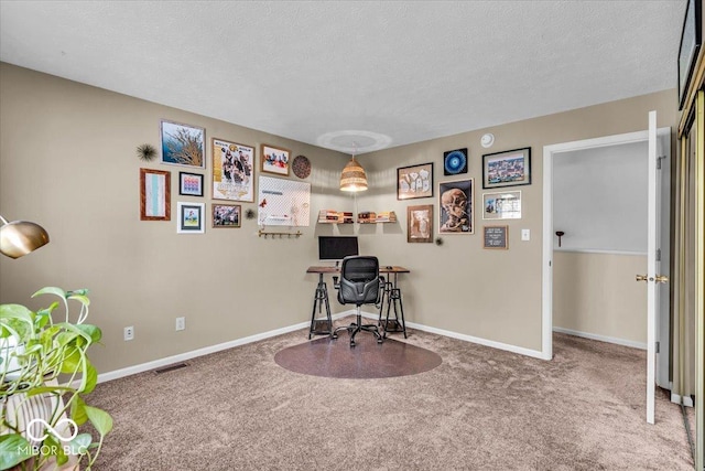 home office with carpet, baseboards, and a textured ceiling