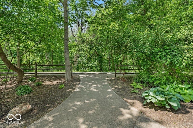 view of home's community featuring fence