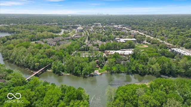 bird's eye view of a nearby body of water and a heavily wooded area