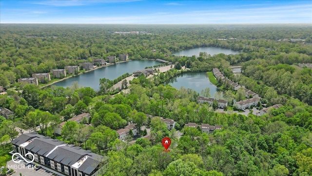 aerial overview of property's location featuring a heavily wooded area and a large body of water