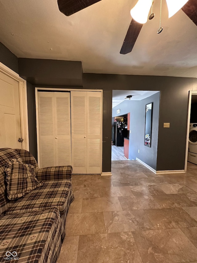 6432 Commons Dr, Indianapolis, IN 46254 - living area featuring baseboards, a ceiling fan, stone tile flooring, and washer / dryer
