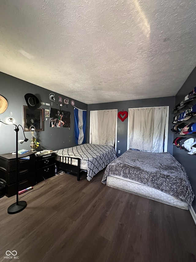 6432 Commons Dr, Indianapolis, IN 46254 - bedroom featuring a textured ceiling and wood finished floors