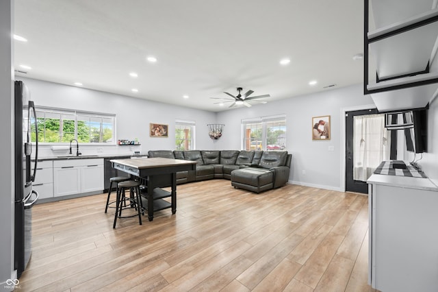 141 W 10th St, Seymour, IN 47274 - living room featuring healthy amount of natural light, recessed lighting, ceiling fan, and light wood finished floors