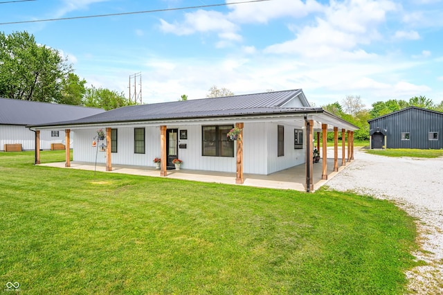 141 W 10th St, Seymour, IN 47274 - rear view of property featuring a lawn, metal roof, a patio, and gravel driveway