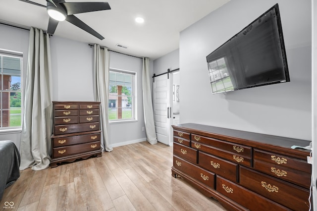 141 W 10th St, Seymour, IN 47274 - bedroom with light wood finished floors, a barn door, baseboards, and ceiling fan