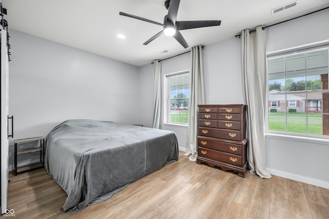 141 W 10th St, Seymour, IN 47274 - bedroom with baseboards, wood finished floors, multiple windows, and recessed lighting