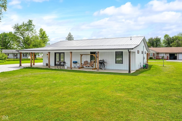 141 W 10th St, Seymour, IN 47274 - back of house with a yard, gravel driveway, metal roof, and board and batten siding