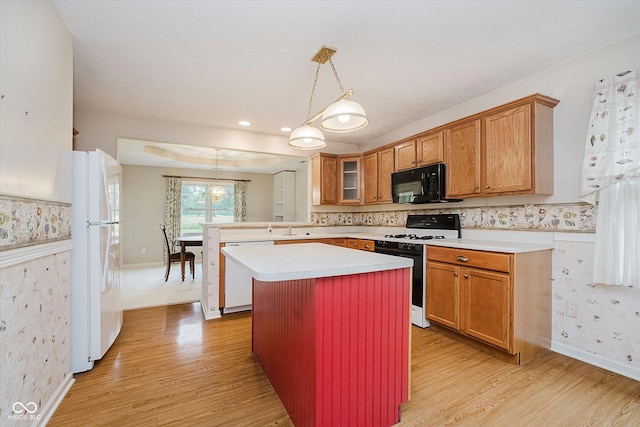 10833 Tournament Ln, Indianapolis, IN 46229 - kitchen with white appliances, light countertops, light wood finished floors, and wallpapered walls