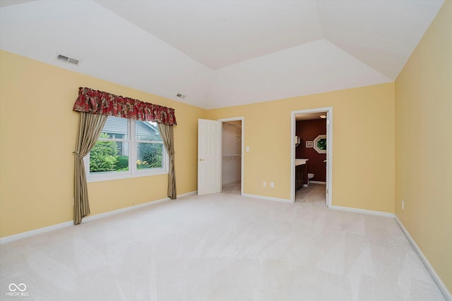 10833 Tournament Ln, Indianapolis, IN 46229 - unfurnished bedroom featuring light colored carpet, lofted ceiling, a spacious closet, and a closet