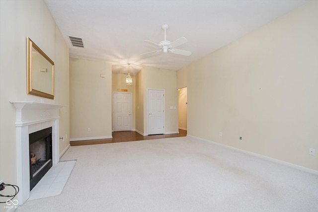 10833 Tournament Ln, Indianapolis, IN 46229 - unfurnished living room with carpet flooring, ceiling fan, and a fireplace