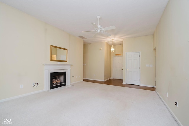 10833 Tournament Ln, Indianapolis, IN 46229 - unfurnished living room with carpet, a ceiling fan, and a fireplace with flush hearth