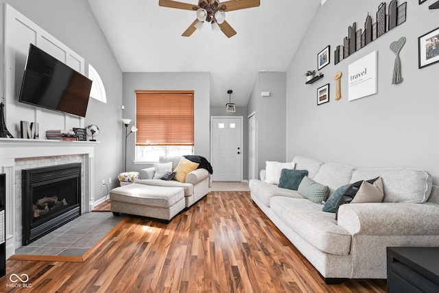 9404 Enclave Dr Unit D, Avon, IN 46123 - living area with a ceiling fan, vaulted ceiling, wood finished floors, and a tiled fireplace