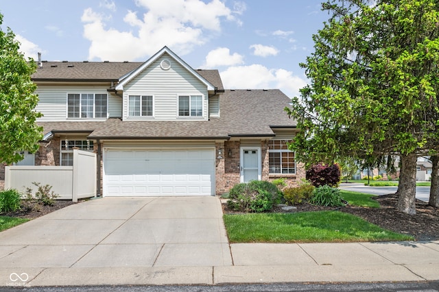 9404 Enclave Dr Unit D, Avon, IN 46123 - view of property with concrete driveway, an attached garage, brick siding, and roof with shingles