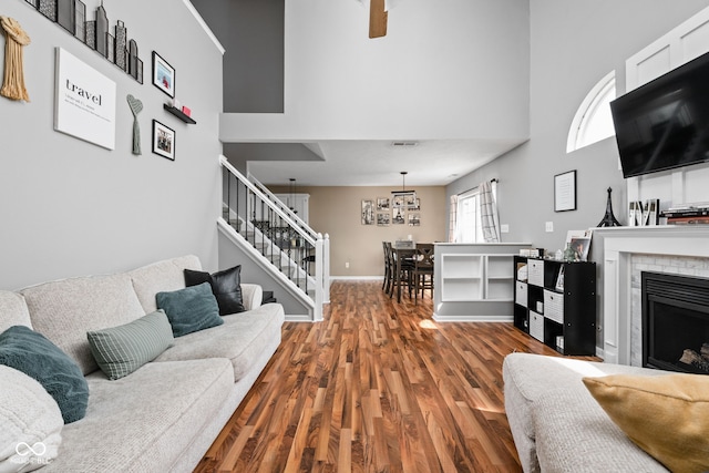 9404 Enclave Dr Unit D, Avon, IN 46123 - living area with stairway, a high ceiling, wood finished floors, and a fireplace