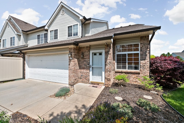 9404 Enclave Dr Unit D, Avon, IN 46123 - view of front facade featuring driveway, an attached garage, stone siding, and a shingled roof