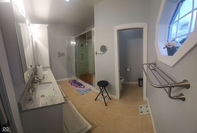 5415 S Chalmers Ct, Bloomington, IN 47403 - full bathroom featuring double vanity, a shower stall, toilet, baseboards, and lofted ceiling