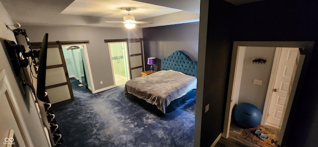 5415 S Chalmers Ct, Bloomington, IN 47403 - bedroom featuring a barn door, baseboards, ensuite bath, and a ceiling fan