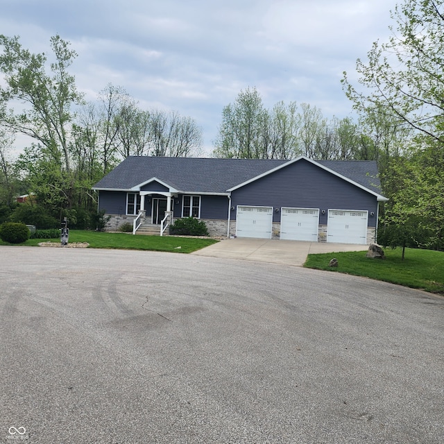 5415 S Chalmers Ct, Bloomington, IN 47403 - single story home with concrete driveway, a garage, a front yard, and a shingled roof