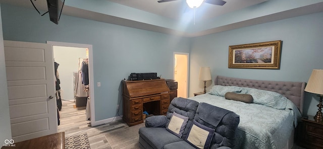 5415 S Chalmers Ct, Bloomington, IN 47403 - bedroom with light wood-style floors, a walk in closet, a ceiling fan, baseboards, and a closet