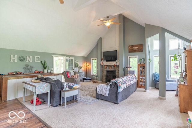 1409 S Northview Dr, Martinsville, IN 46151 - living room featuring high vaulted ceiling, ceiling fan, a fireplace, and wood finished floors