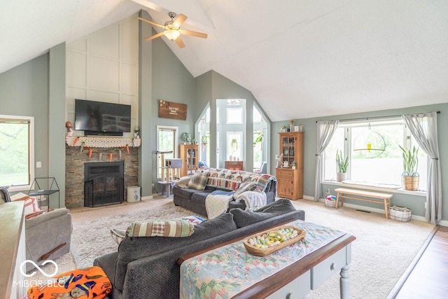 1409 S Northview Dr, Martinsville, IN 46151 - living area featuring high vaulted ceiling, a ceiling fan, baseboards, a stone fireplace, and light wood-style floors