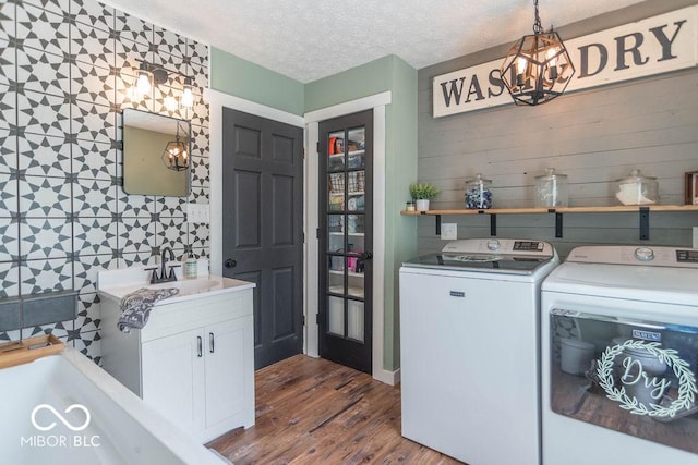 1409 S Northview Dr, Martinsville, IN 46151 - clothes washing area with washing machine and clothes dryer, a chandelier, dark wood-type flooring, cabinet space, and a textured ceiling