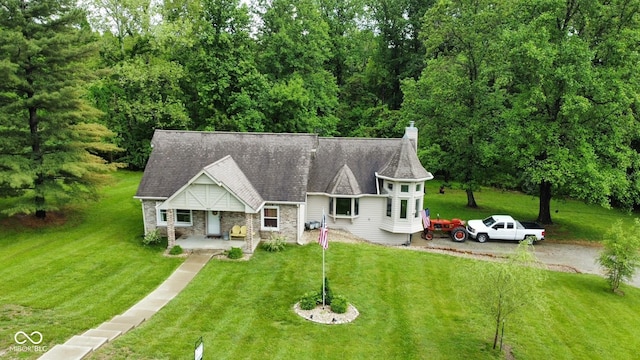 1409 S Northview Dr, Martinsville, IN 46151 - view of front of house featuring covered porch, a front yard, a chimney, and stone siding