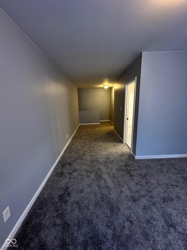 spare room with carpet and baseboards