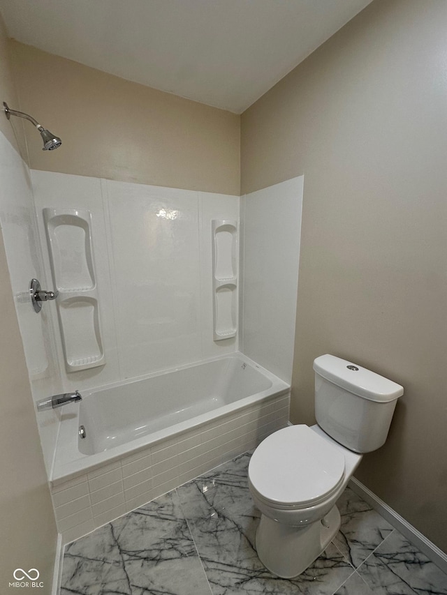 bathroom with marble look tile flooring, toilet, shower / washtub combination, and baseboards