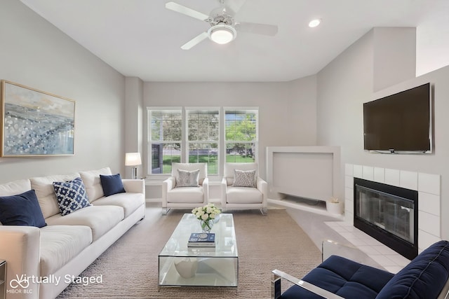 carpeted living room featuring ceiling fan, a tile fireplace, and recessed lighting