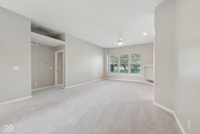 empty room with a ceiling fan, carpet floors, and baseboards