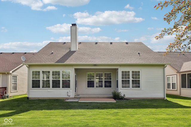 back of house with a lawn, a patio, and a chimney