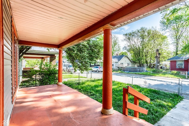 view of patio / terrace featuring fence and a residential view