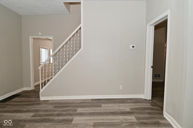 623 Orange St, Indianapolis, IN 46203 - entryway with dark wood finished floors, stairway, and baseboards