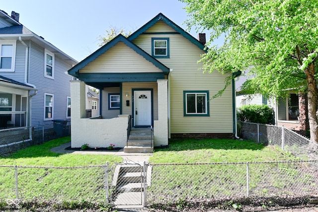 623 Orange St, Indianapolis, IN 46203 - view of front of home featuring a gate, a chimney, and a porch