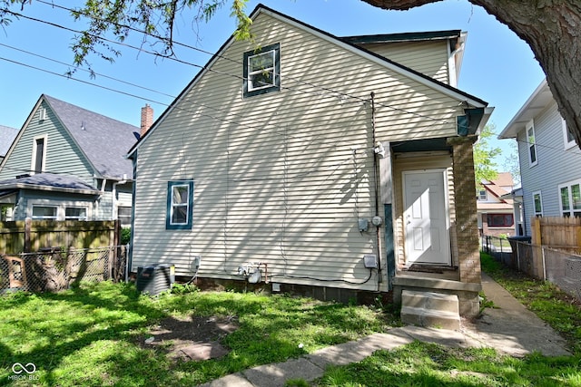 623 Orange St, Indianapolis, IN 46203 - rear view of house featuring fence and central AC