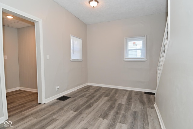 623 Orange St, Indianapolis, IN 46203 - unfurnished room featuring wood finished floors, baseboards, and a textured ceiling