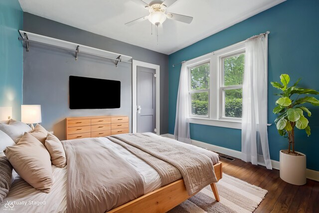 bedroom with baseboards, wood finished floors, and a ceiling fan