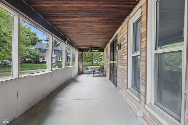 view of patio / terrace with ceiling fan, covered porch, and fence